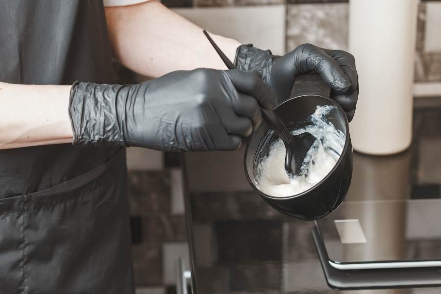 person mixing home hair dye kit